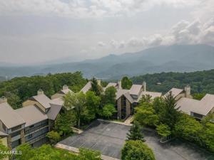 an aerial view of a house with a parking lot at Misty Mountain Condo by Beyond Expectations- 3BR Retreat with Scenic Views, Sleeps 8 & Near Ober Mountain in Gatlinburg