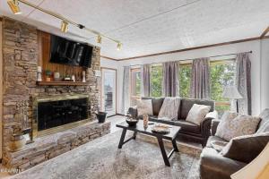 a living room with a couch and a fireplace at Misty Mountain Condo by Beyond Expectations- 3BR Retreat with Scenic Views, Sleeps 8 & Near Ober Mountain in Gatlinburg