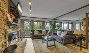 a living room with a couch and a fireplace at Misty Mountain Condo by Beyond Expectations- 3BR Retreat with Scenic Views, Sleeps 8 & Near Ober Mountain in Gatlinburg +46 photos