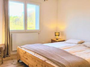 a bedroom with two beds and a window at Cœurvert Nature Silence, Panorama - Ronchamp & Le Corbusier in Ronchamp