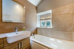 a bathroom with a sink and a tub and a mirror at 2 Bed in Middleton oc-m29515 in Middleton +18 photos
