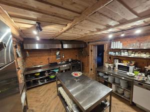 a large kitchen with a table in the middle at Leśna Ostoja in Goworów