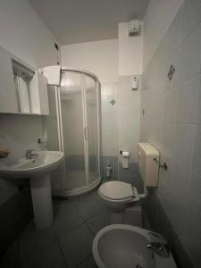 a bathroom with a shower and a toilet and a sink at ALBERGO DELLA STAZIONE in Cairo Montenotte