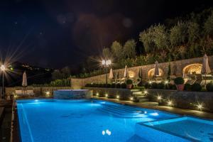 a swimming pool at night with lights at Borgo dei Gigli in Lamporecchio