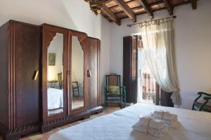 a bedroom with a bed and a large mirror at Casa Arizo, Hotel Boutique & Bike Friendly in Oropesa del Mar