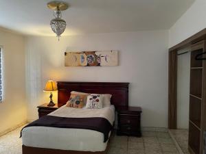 a bedroom with a bed and a chandelier at Se Renta Casa in Saltillo