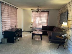 a living room with a couch and a table at Se Renta Casa in Saltillo