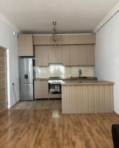 an empty kitchen with a refrigerator and a counter top at Sweet and New Apartment , Cit Center, Best Location in Yerevan