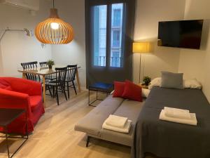 a living room with a bed and a dining room at 555 Apartments BCN in Barcelona