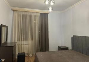 a bedroom with a bed and a window with curtains at Sweet and New Apartment , Cit Center, Best Location in Yerevan