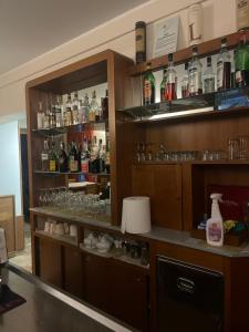 a bar with lots of glasses and bottles on shelves at ALBERGO DELLA STAZIONE in Cairo Montenotte +24 photos