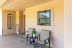 a porch with three chairs and a window at Gatehouse Condo by Beyond Expectations w Views in Gatlinburg