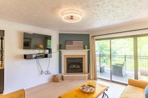 a living room with a fireplace with a flag on the wall at Gatehouse Condo by Beyond Expectations w Views in Gatlinburg +63 photos