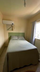 a bedroom with a large bed with a window at Apartamento vita bella in Porto Velho +19 photos