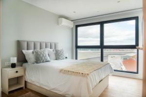 a bedroom with a bed and a large window at Victory Suites in Gibraltar +67 photos
