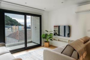 a living room with a couch and a large window at Victory Suites in Gibraltar
