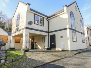 a large white building with a large door at Capel Y Ffynnon in Llandudno Junction