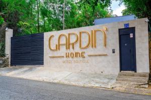 a sign for a carolina home on the side of a building at Gardin Home in Cali