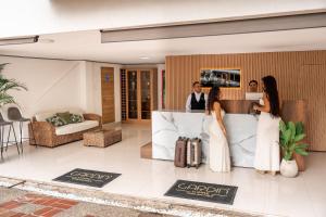 a group of people standing in a hotel lobby at Gardin Home in Cali +77 photos