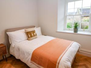 a bedroom with a bed and a window at The Reading Room in Grindleford Bridge