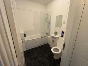 a white bathroom with a toilet and a sink at One Bedroom flat in Doncaster Prime Location in Doncaster