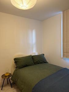 a bedroom with a bed and a lamp at 5 Bed Cottage in Enfield +1 photo