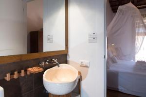 a bathroom with a sink and a bed at Casa Arizo, Hotel Boutique & Bike Friendly in Oropesa del Mar +86 photos