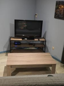 a flat screen tv sitting on top of a tv stand at L'Orée du bois in Membre