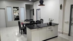 a kitchen with a table and chairs in a room at Zosang Homestay in Āīzawl