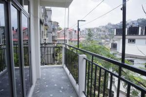 a balcony with a view of a city at Zosang Homestay in Āīzawl +8 photos