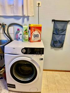 a washing machine with cleaning products on top of it at Myranhuset - Amazing View in Moskenes