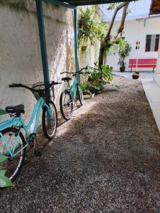 three bikes are parked next to a building at Vereda da Lagoa in Niterói