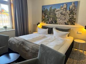 a hotel room with a bed and a picture on the wall at Harzhotel Warnstedter Krug in Thale +85 photos