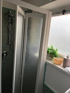 a shower with a glass door in a bathroom at Sara House Palermo in Palermo