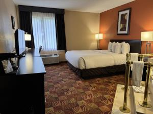a hotel room with a bed and a flat screen tv at Baymont by Wyndham Plainfield/ Indianapolis Arpt Area in Plainfield +50 photos