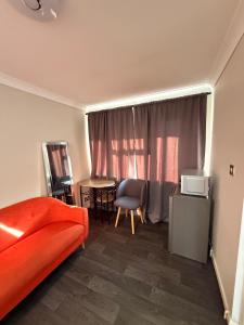 a bedroom with a bed and a table and chairs at Demure Living Space in Southampton