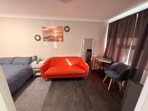 a bedroom with a bed and a chair and a desk at Demure Living Space in Southampton