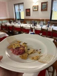 a plate of food on a table in a restaurant at ALBERGO DELLA STAZIONE in Cairo Montenotte