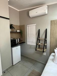 a room with a refrigerator and a air conditioner on the wall at Stay at Tzaneen in Tzaneen +7 photos