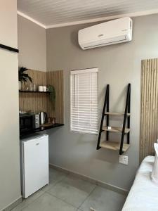 a room with a refrigerator and a air conditioner on the wall at Stay at Tzaneen in Tzaneen