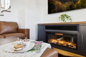 a table with a plate of food and a fireplace at Lighthouse Lookout by Beyond Expectations - Hot Tub & Lake Views in Sevierville