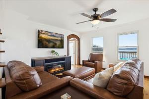 a living room with a couch and a fireplace at Lighthouse Lookout by Beyond Expectations - Hot Tub & Lake Views in Sevierville +49 photos
