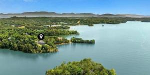 an island in the middle of a lake at Lighthouse Lookout by Beyond Expectations - Hot Tub & Lake Views in Sevierville