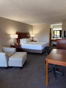 a hotel room with two beds and a couch and a table at Great Smokies Inn - Cherokee in Cherokee +37 photos