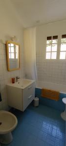 a bathroom with a sink and a tub and a toilet at Le Village Champignon in Aspet