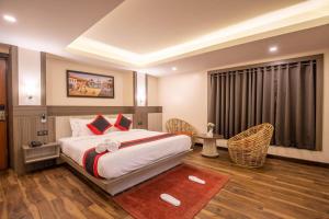 a hotel room with a bed and a window at The Resident Kathmandu in Kathmandu