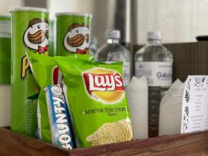 a basket of snacks and bottles of water and soda at The Resident Kathmandu in Kathmandu