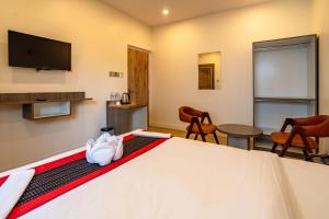a room with a bed and a flat screen tv at The Resident Kathmandu in Kathmandu +24 photos