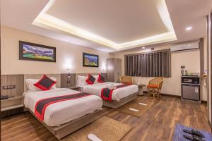 a hotel room with two beds and a kitchen at The Resident Kathmandu in Kathmandu