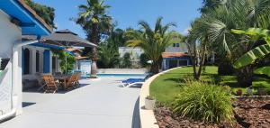 a villa with a swimming pool next to a house at Studio proche de l'Océan - Calme et Pratique in Capbreton